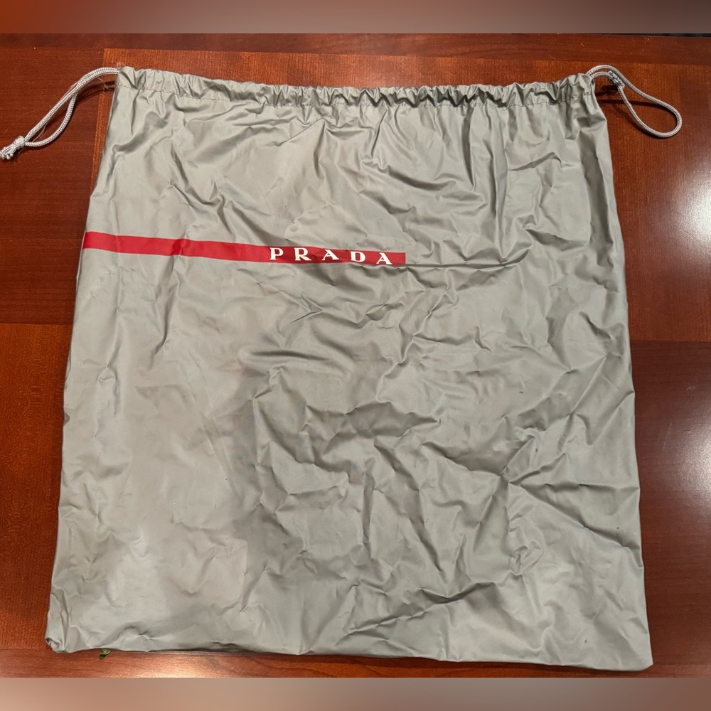 PRADA GRAY SHOE BAG WITH DRAWSTRINGS AND RED STRIPE LOGO. SIZE: 17”x16”